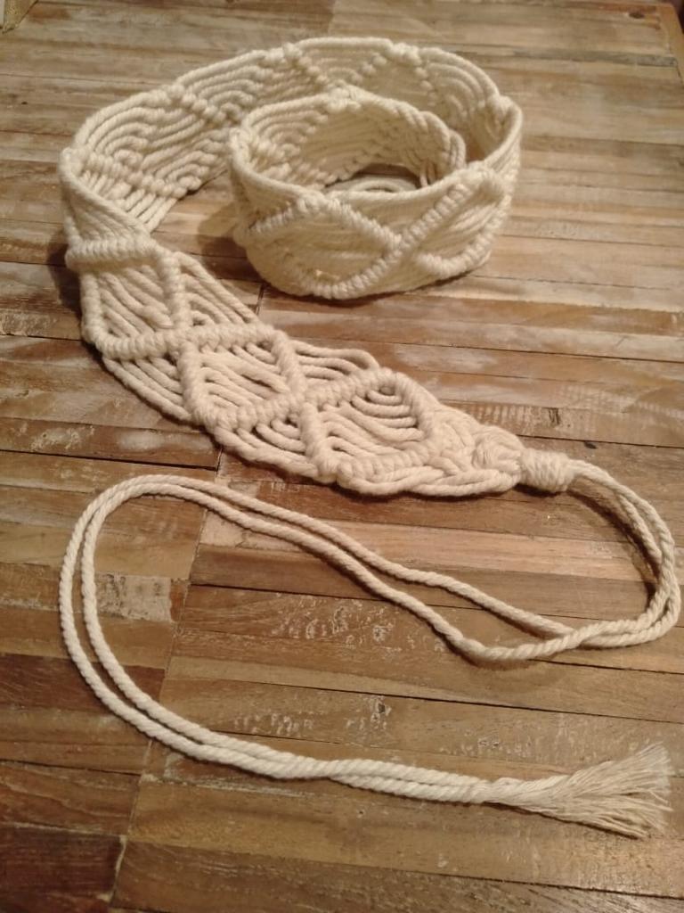 Handmade macrame belt on craft paper background. ECO friendly natural  macrame cotton belt. Hobby knitting handmade macrame. Modern summer  concept. Stock Photo